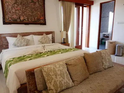 a bedroom with a large bed and a couch at ★ VIP ★ Green Studio Apartment in Seminyak, No.23 in Seminyak