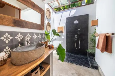 a bathroom with a sink and a bath tub at Villa Makasih by Villa Finder in Seminyak