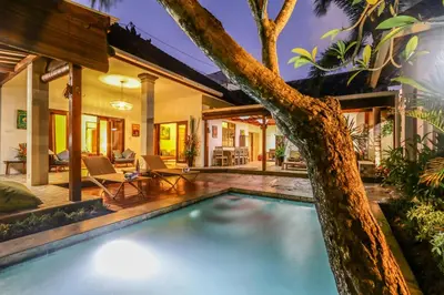 a swimming pool in the backyard of a house at Villa Mira in Seminyak