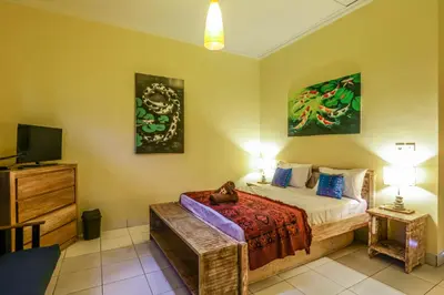 a bedroom with a bed and a tv in it at Villa Mira in Seminyak