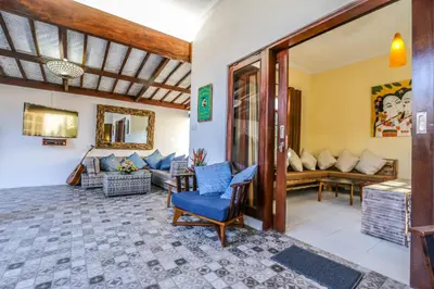 a living room with a blue chair and a couch at Villa Mira in Seminyak