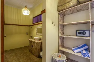 a bathroom with a sink and a toilet and a mirror at Villa Mira in Seminyak