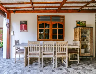 a dining room with a wooden table and chairs at Villa Mira in Seminyak