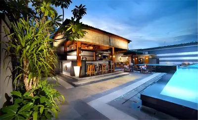a villa with a swimming pool and a house at The Banyumas Villa in Denpasar