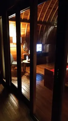 a room with a view of a living room at The Lumbung Wood Villa in Seminyak