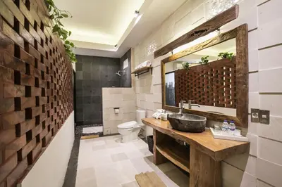 a bathroom with a sink and a toilet at Sunset Paradise at Temple Hill Jimbaran in Jimbaran