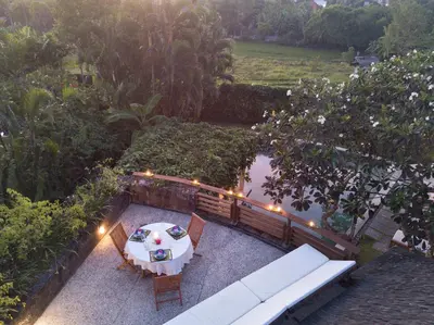 an overhead view of a table and chairs in a garden at Villas Sin Sin in Canggu