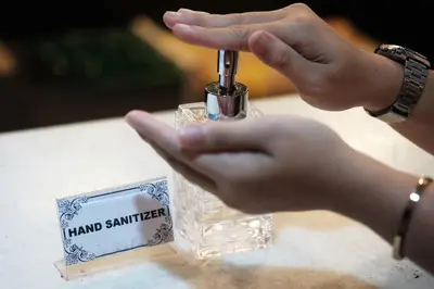 a person is holding a bottle of hand sanitizer at Villas Sin Sin in Canggu