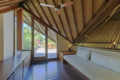 a room with a bed and a ceiling fan at Villas Sin Sin in Canggu