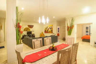 a living room with a table and a couch at Bali Mystique Hotel & Apartment in Seminyak