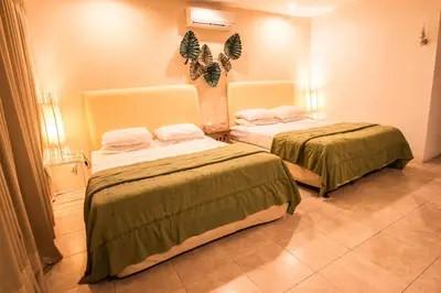 a room with two beds in a room at Bali Mystique Hotel & Apartment in Seminyak