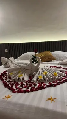 a bed with swans made out of flowers on it at Bali Elephants Boutique Villa in Jimbaran