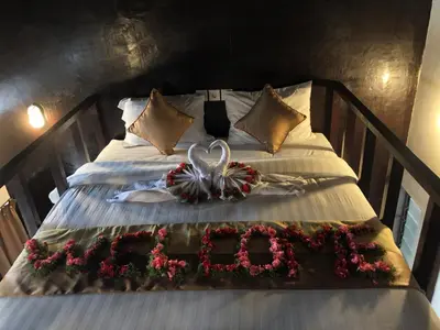 a bed with a bouquet of flowers on it at Bali Elephants Boutique Villa in Jimbaran