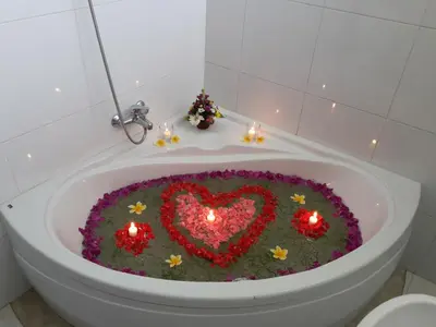 a bath tub with a heart made out of flowers at Bali Elephants Boutique Villa in Jimbaran