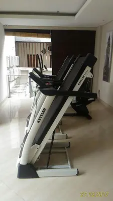 a gym with a treadmill in a room at Ohana Hotel Kuta in Kuta
