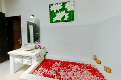 a bathroom with a red rug on the floor at Villa Marick in Seminyak
