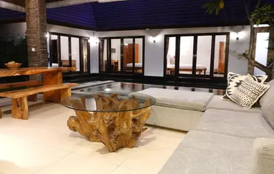 a living room with a tree stump coffee table at Villa Marick in Seminyak