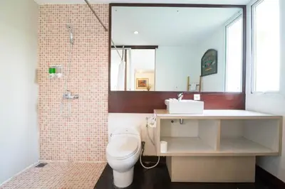 a bathroom with a toilet and a sink and a shower at Aqua Bali Villa in Canggu