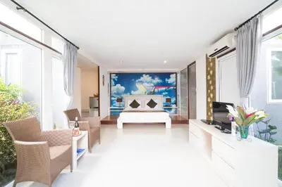 a living room with a large painting on the wall at Aqua Bali Villa in Canggu
