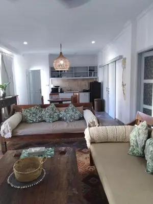 a living room with a couch and a table at Bali Court Hotel & Apartment in Legian