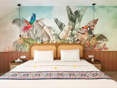 a bedroom with a bed and a mural of birds at Kumpul Kumpul Villa Seminyak - CHSE Certified in Seminyak