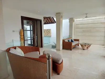 a living room with a couch and a chair at Villa Harmony - Residence in Seminyak