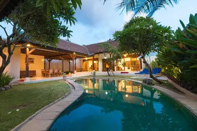 an exterior view of a villa with a swimming pool at Bali Royal Heritage Villas in Seminyak