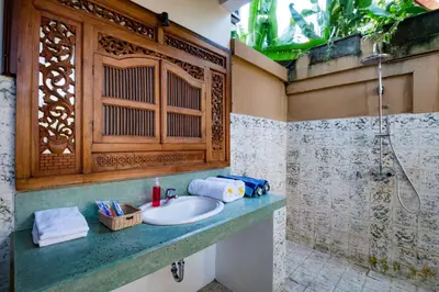 a bathroom with a sink and a shower at Bali Royal Heritage Villas in Seminyak