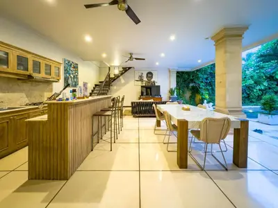 a kitchen and dining room with a table and chairs at Villa Bugis Kayu Aya Seminyak in Seminyak