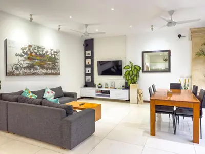a living room with a couch and a table at Villa Bugis Kayu Aya Seminyak in Seminyak