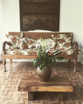 a couch in a living room with a vase on a table at Villa Jalun in Seminyak