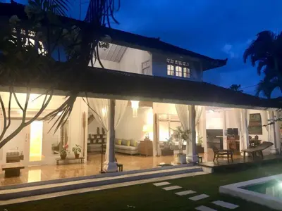 a villa with a swimming pool at night at Villa Jalun in Seminyak