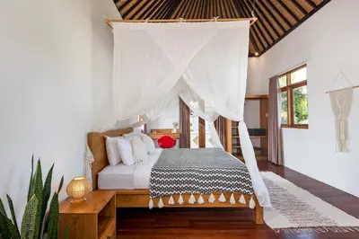 a bedroom with a bed with a canopy at Unicorn Shelter Villa in Seminyak