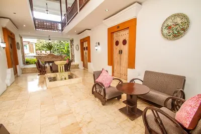 a living room with a table and chairs at Abian Biu Mansion in Canggu