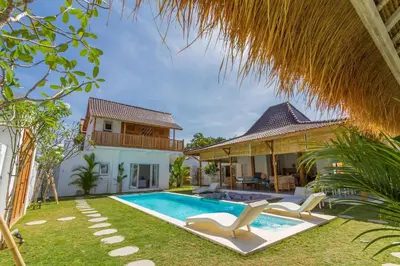 a backyard with a swimming pool and a house at Villa Opaline by Alfred in Bali in Seminyak