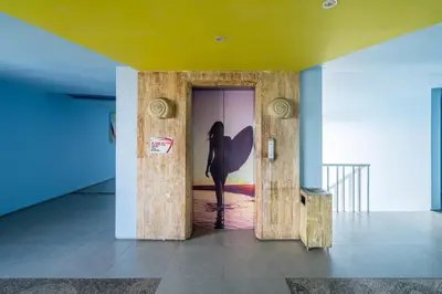 a woman standing in the door of a room at Bliss Surfer Hotel Legian in Legian
