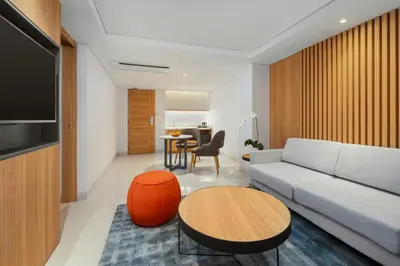 a living room with a couch and a table at Holiday Inn Express Bali Sunset Road by IHG in Kuta
