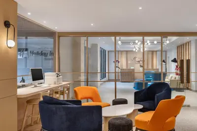 an office with orange and blue chairs and a desk at Holiday Inn Express Bali Sunset Road by IHG in Kuta