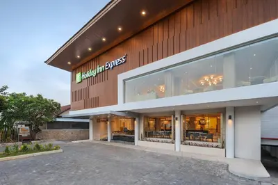 a store front of a building with glass windows at Holiday Inn Express Bali Sunset Road by IHG in Kuta