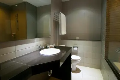 a bathroom with a sink and a toilet at 100 Sunset Kuta Hotel & Ballroom in Kuta
