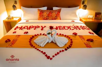 a bed with two swans made out of hearts at Ananta Legian Hotel in Legian