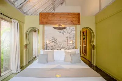 a bedroom with a large bed with white pillows at Space Villas Bali in Seminyak