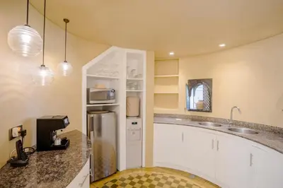 a kitchen with a sink and a refrigerator at Space Villas Bali in Seminyak