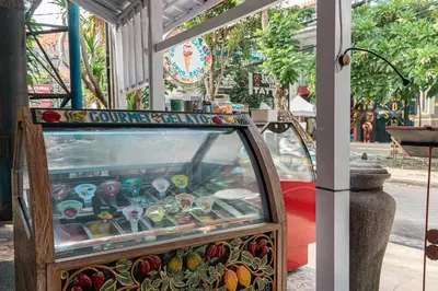 a pinball machine sitting in front of a building at Bali Summer Hotel by Amerta in Kuta