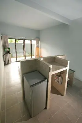a living room with a counter and a table at The Grey Boutique Inn in Legian