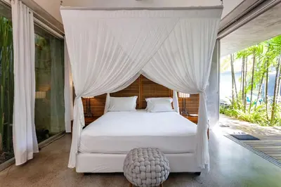 a bedroom with a white bed with a canopy at Villa C88 Seminyak in Seminyak