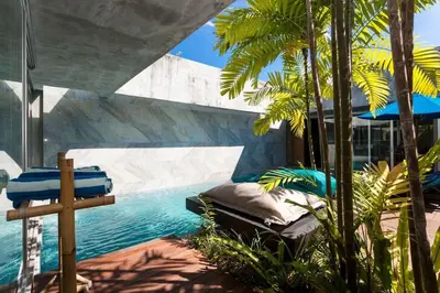 a swimming pool in the middle of a resort at Villa C88 Seminyak in Seminyak
