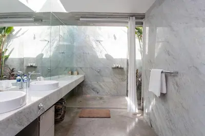 a bathroom with two sinks and a shower at Villa C88 Seminyak in Seminyak