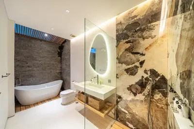 a bathroom with a tub and a sink and a toilet at Villa Esa Seminyak in Seminyak