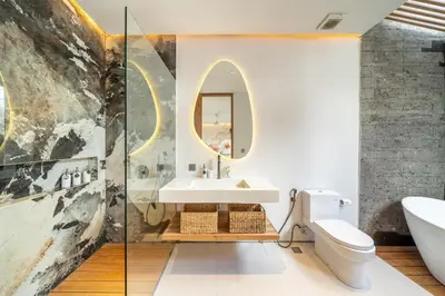 a bathroom with a sink and a toilet and a mirror at Villa Esa Seminyak in Seminyak
